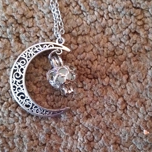 This is a silver toned Crescent Moon with a floating Heart in the middle NWOT!! - Picture 1 of 1